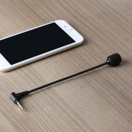 BOYA Microphone for Daily Smartphone Recording and Vlogging attached to phone on wood surface, omni-directional lavalier-style mic for vlogs and voiceovers