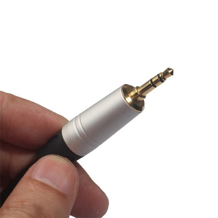 Compact audio cable for everyday music connections at home — close-up of 3.5mm to Canon connector hand-held cable