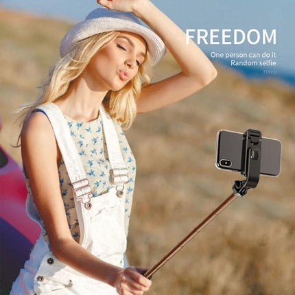 Selfie Stick for Capturing Daily Moments and Travel Memories – woman taking a beach selfie with adjustable 7-length extendable stick