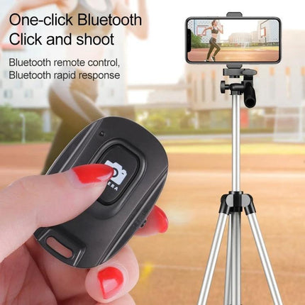Compact Wireless Bluetooth One-Button Selfie Remote for Smartphones shown held in hand with phone on tripod, one-button shutter control for group photos and vlogging