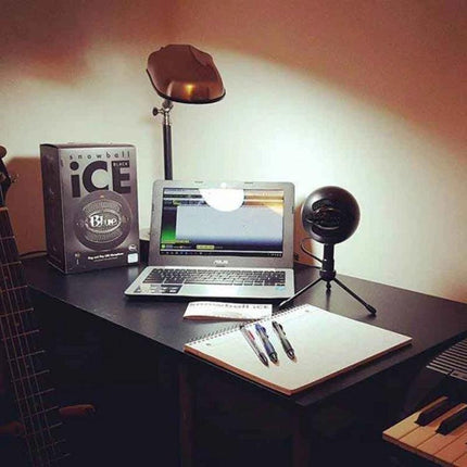Logitech Microphone for Everyday Home Recordings and Calls on desk with laptop, notebook, lamp and compact plug-and-play setup