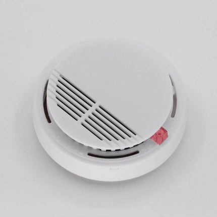 First Alert Battery-Operated Smoke Alarm for Home Safety mounted on ceiling, compact white smoke detector with test/reset button