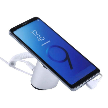 Cylindrical Display Stand for Mobile Phones with Anti-Theft Security showing phone on stand with charging cable and security tether