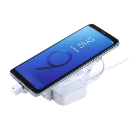 Anti-Theft Alarm Stand for Mobile Phones with Type-C Port displaying a retail smartphone on a white security charging stand