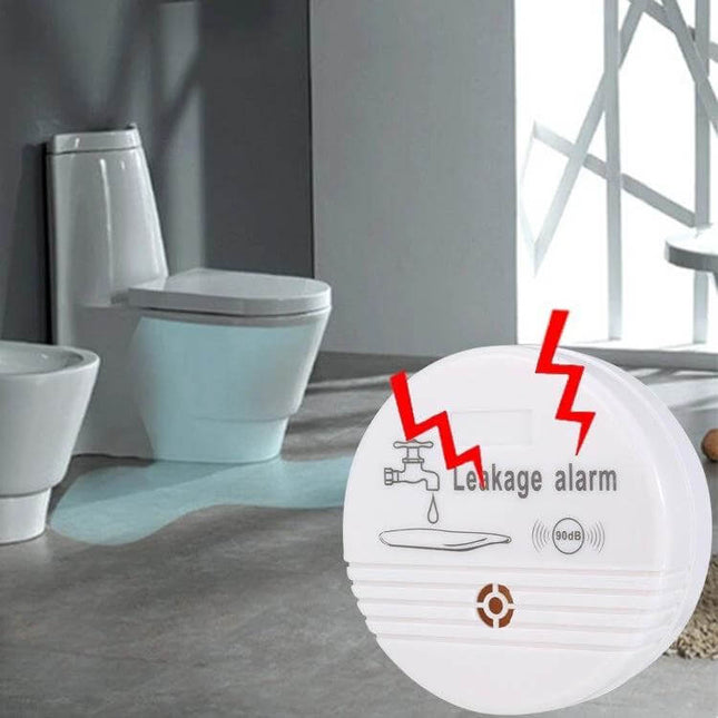 Water Leak Detector Alarm for Home Floors and Appliances placed near bathroom toilet detecting floor leak and sounding alarm