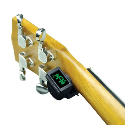 JOYO Clip-On Tuner for Everyday Instrument Practice Sessions attached to a guitar headstock showing green digital display