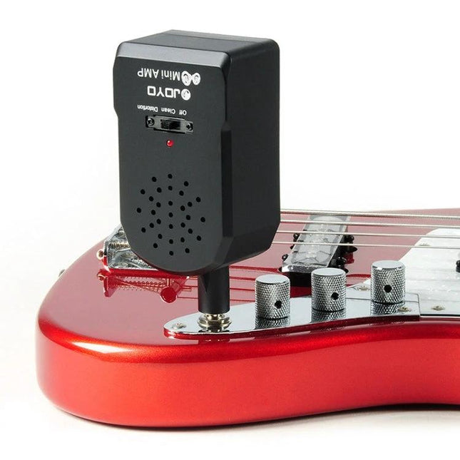 JOYO Compact Amplifier for Everyday Guitar Practice On the Go plugged into red electric guitar for portable practice