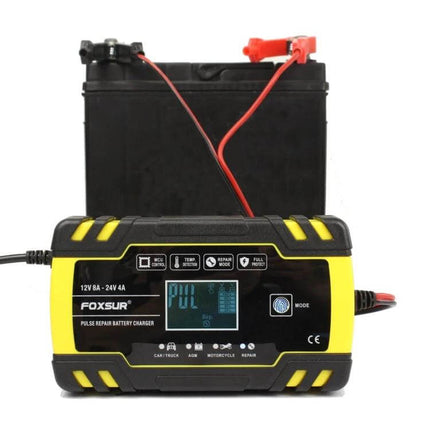 Foxsur 12V-24V Battery Charger for Cars and Motorcycles connected to a car battery, compact pulse repair charger for car and motorcycle maintenance
