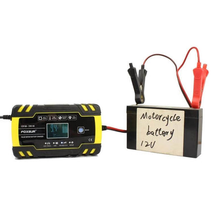 Foxsur 12V-24V Battery Charger for Cars and Motorcycles connected to a 12V motorcycle battery with clamp leads