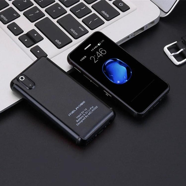 Compact Android Device with Bluetooth and WiFi Connectivity – compact black secondary Android phone for travel with Bluetooth and WiFi, shown beside laptop