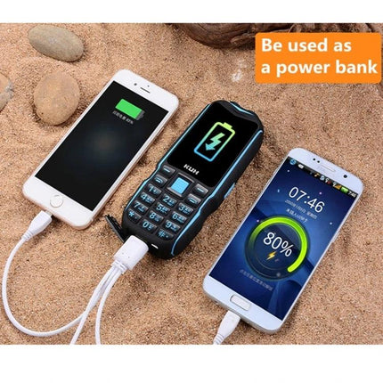 Durable Rugged Phone for Outdoor Use with Dust and Shock Protection shown charging two smartphones on sandy terrain