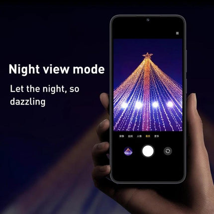Essential Smartphone for Daily Communication and Entertainment showing night view mode capturing a bright illuminated tower scene