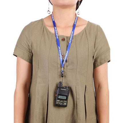 BaoFeng BF-T1 Compact Handheld Walkie Talkie with US Plug hanging on lanyard worn around neck