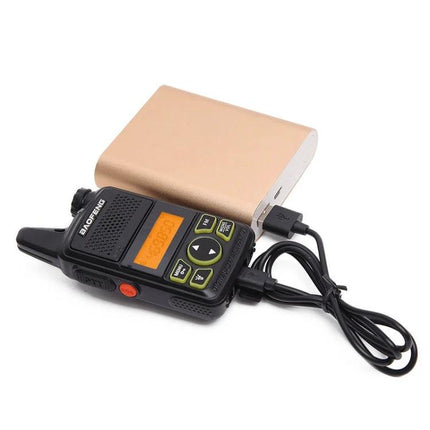 BaoFeng BF-T1 Compact Handheld Walkie Talkie for Everyday Use showing compact radio beside power bank and USB charging cable