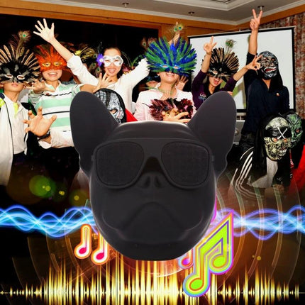 Compact Portable Bluetooth Speaker For Home And Travel Use shown as black dog-ear speaker with party masks and music graphics around
