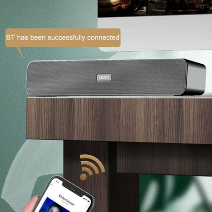 LEERFEI Compact Bluetooth Speaker For Home And Travel sleek aluminum portable speaker on table with phone showing BT connected
