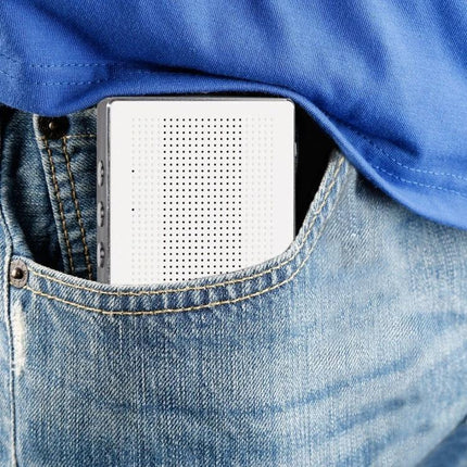 Compact Portable Bluetooth Speaker For Everyday Music tucked in jeans pocket, portable wireless speaker with controls and mic