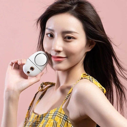 Makeup Mirror Spray For Daily Hydration During Routine — woman holding portable nano-mist mirror for makeup touch-ups and setting