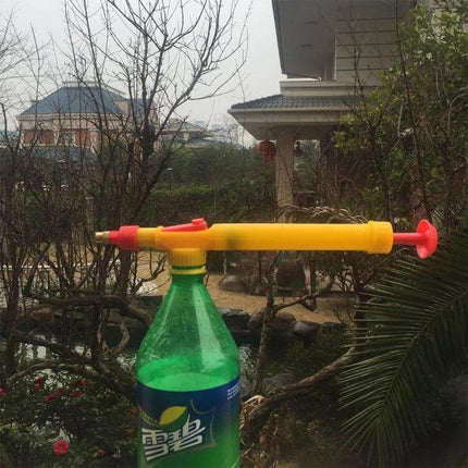Manual Pressure Bottle Sprayer For Garden Watering attached to a standard plastic beverage bottle for watering seedlings and potted plants