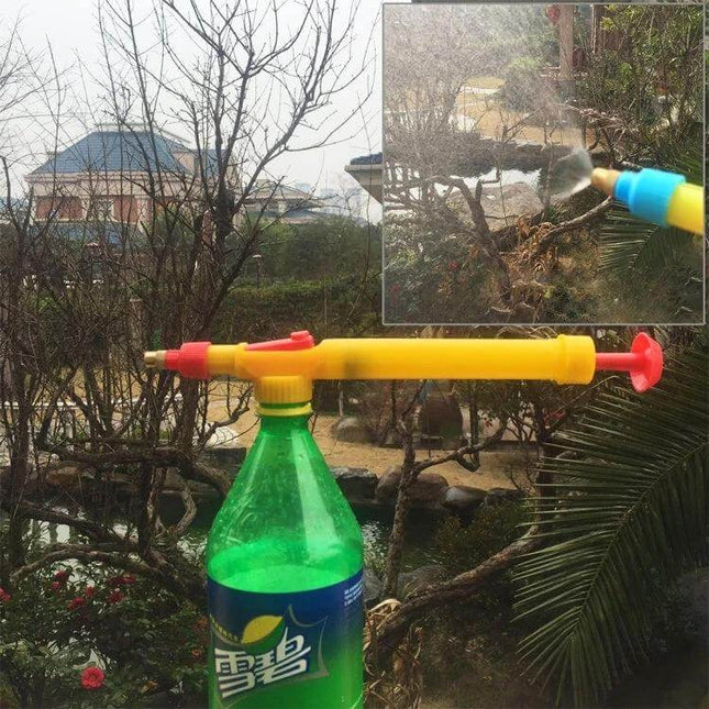 Manual Pressure Bottle Sprayer For Garden Watering clipped to a standard beverage bottle showing spray wand misting plants