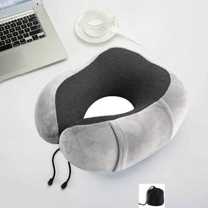 Memory Foam U-Shaped Travel Pillow For Neck Support in grey velvet with adjustable drawstring and compact carry pouch, shown on desk with laptop and cup
