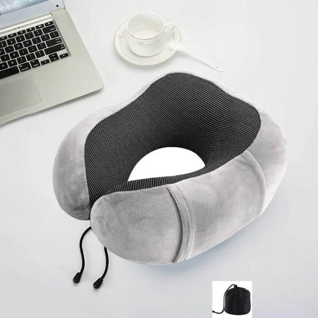 Memory Foam U-Shaped Travel Pillow For Neck Support in grey velvet with adjustable drawstring and compact carry pouch, shown on desk with laptop and cup