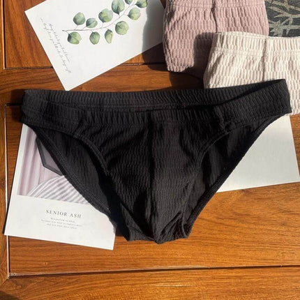 Men's Pure Cotton Triangle Underwear Solid Color Shorts black triangle brief on wood surface, breathable 40-thread cotton, mid-rise everyday wear