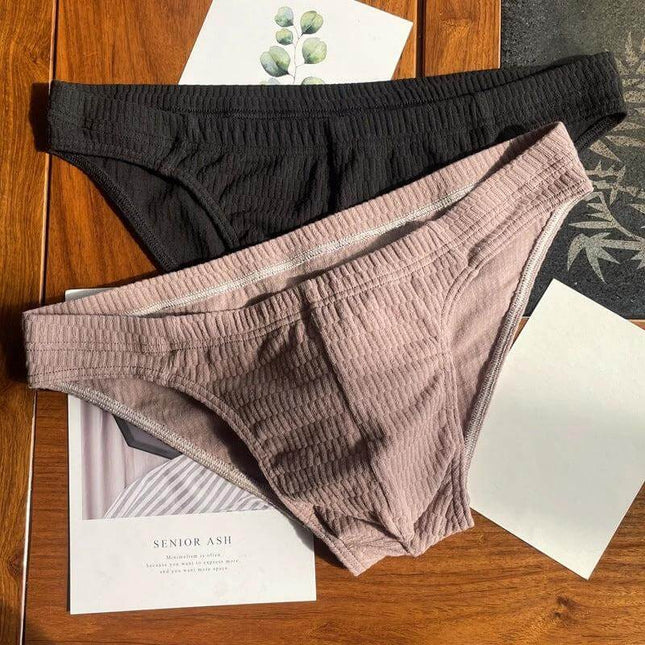 Men's Pure Cotton Triangle Underwear Solid Color Shorts displayed in black and mauve on a wooden surface, breathable 40-thread weave triangle briefs
