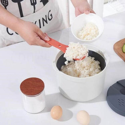 Microwave Rice Cooker 2L Steamer Pot For Easy Rice — person scooping cooked rice from compact 2L food-grade PP microwave steamer