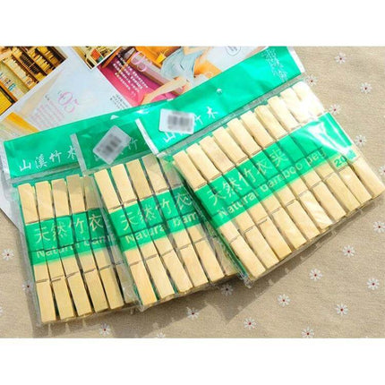 Mini Bamboo Clothes Pegs Pack For Laundry And Home Use - multiple packs of natural mini bamboo clothespins arranged on fabric