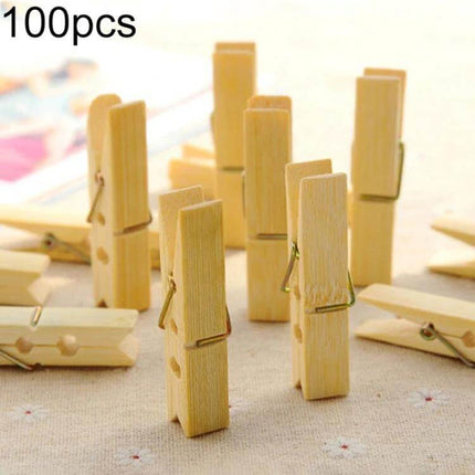 Mini Bamboo Clothes Pegs Pack For Laundry And Home Use - 100pcs mini bamboo clothespins displayed standing and scattered for laundry and household use