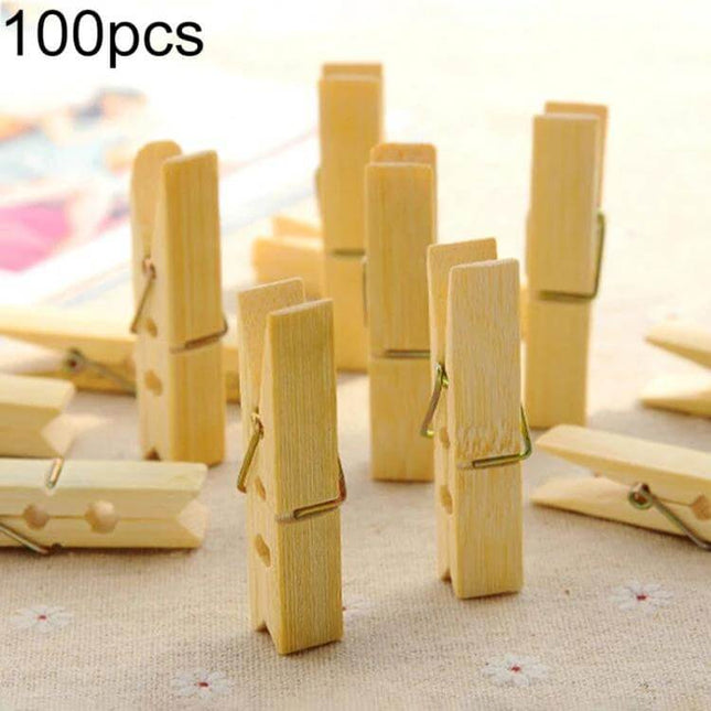Mini Bamboo Clothes Pegs Pack For Laundry And Home Use - 100pcs mini bamboo clothespins displayed standing and scattered for laundry and household use