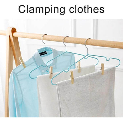 Mini Bamboo Clothes Pegs Pack For Laundry And Home Use securing towels and shirt on a wooden clothes rack