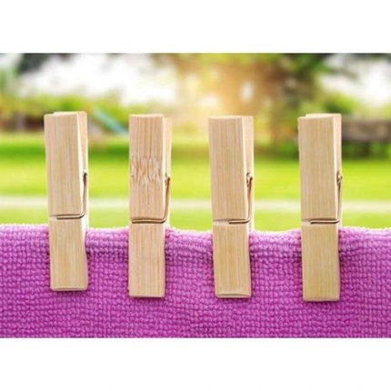 Mini Bamboo Clothes Pegs Pack For Laundry And Home Use - four natural bamboo mini pegs securing pink towel on clothesline outdoors