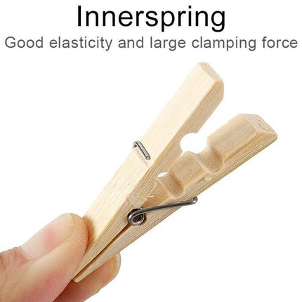 Mini Bamboo Clothes Pegs Pack For Laundry And Home Use - close-up of a mini natural bamboo clothespin showing inner spring and clamping grooves