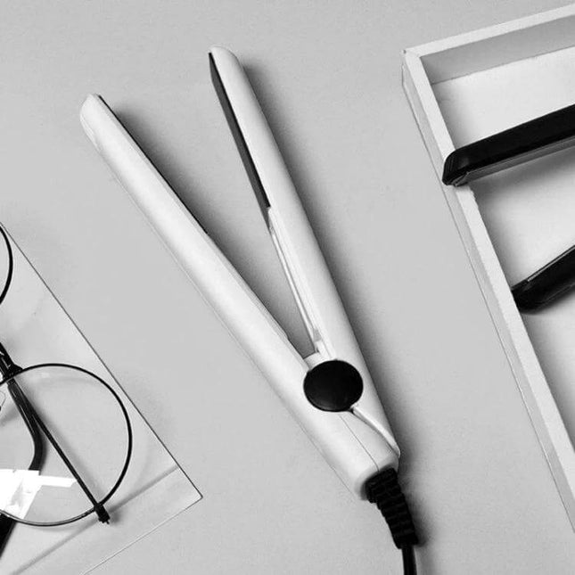 Mini Hair Straightener And Curler One Button Operation portable white mini flat iron for travel, shown beside glasses and accessories