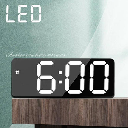 Mirror Bedside Alarm Clock Arc Shaped On Nightstand sleek black LED mirror alarm clock on nightstand showing 6:00, compact ABS shell with large digits