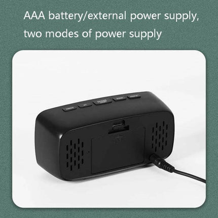 Mirror Bedside Alarm Clock Arc Shaped On Nightstand showing back view with AAA battery compartment and external power cable connection