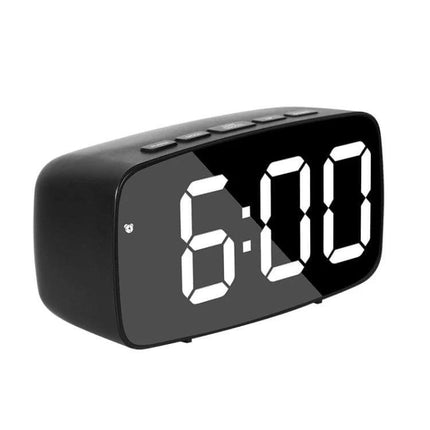 Mirror Bedside Alarm Clock Arc Shaped On Nightstand black mirrored digital alarm on nightstand showing 6:00, compact ABS shell with large LED display