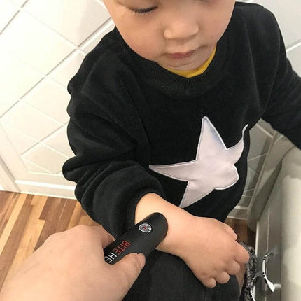 Mosquito Itch Bite Helper Relief Pen For Child And Adult being used on a child’s arm to soothe a mosquito bite with heat and vibration