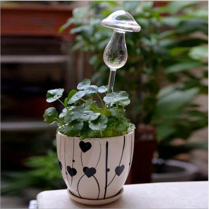Mushroom Shape Glass Self Watering Plant Waterer for Home Plants placed in decorative pot on windowsill, borosilicate glass self-watering mushroom for indoor plants