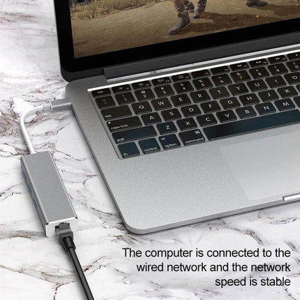 USB-C Adapter for Gigabit Ethernet and Multiple USB Ports connected to laptop providing stable wired network and USB peripheral expansion
