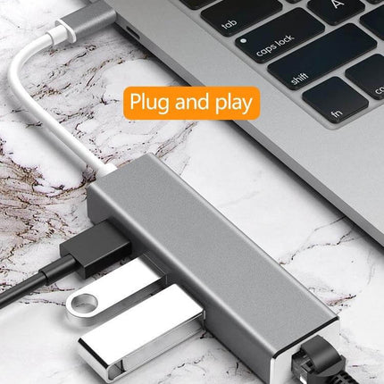 USB-C Adapter for Gigabit Ethernet and Multiple USB Ports showing laptop connection with Ethernet and USB flash drives, plug-and-play setup