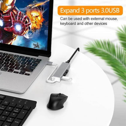 USB-C Adapter for Gigabit Ethernet and Multiple USB Ports shown connected to a laptop with mouse and keyboard for stable wired internet and peripheral expansion