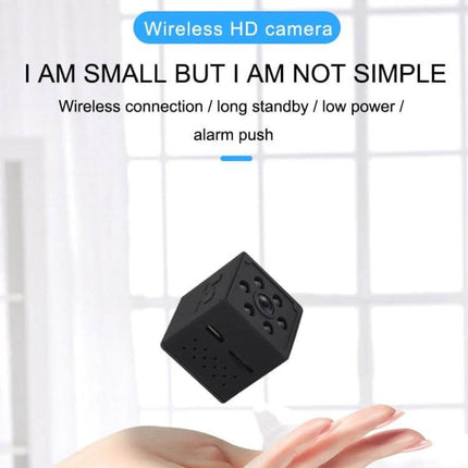 Smart Home WiFi Security Camera with Motion Detection and Night Vision compact cube camera in hand, 1080P HD, motion detection and night vision