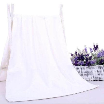 Nano Thickened Bath Towel For Salon And Home Use 30x60cm white compact towel with dense weave and locking edge draped beside lavender basket