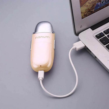 Nanum Facial Hydrating Massager Mini Humidifier For Daily Hydration - portable USB-powered facial humidifier and gentle massager shown beside laptop