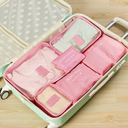 NIBESSER Travel Mesh Packing Cube Set For Clothes, 6 Piece packed pink mesh cubes organized in an open suitcase