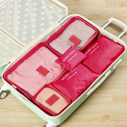 NIBESSER Travel Mesh Packing Cube Set For Clothes, 6 Piece neatly organized in pink mesh cubes inside open suitcase