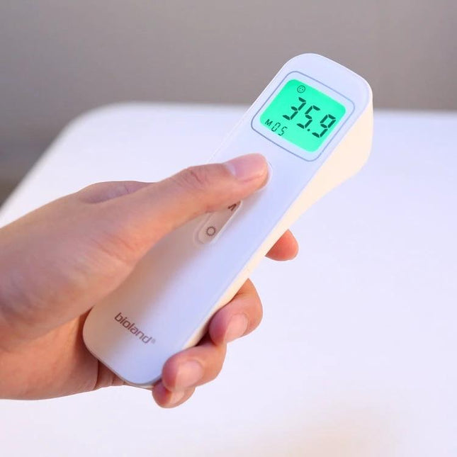 Non Contact Ear And Forehead Infrared Thermometer For Family Use held in hand showing 35.9°C quick one-second non-contact reading